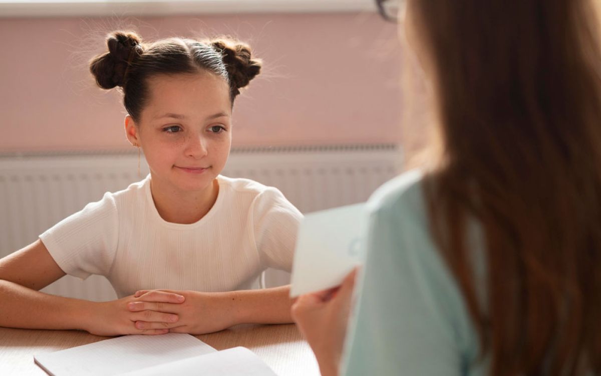 A smiling kid talking with her mother